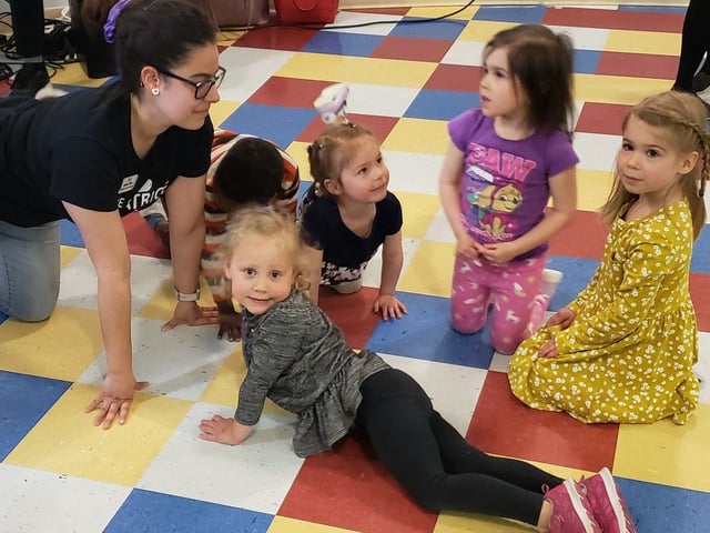 Daycare provider Josée Ross plays with children ahead of a major funding announcement at Au P'tit Monde de Franco in Fredericton in this file photo from 2023. 