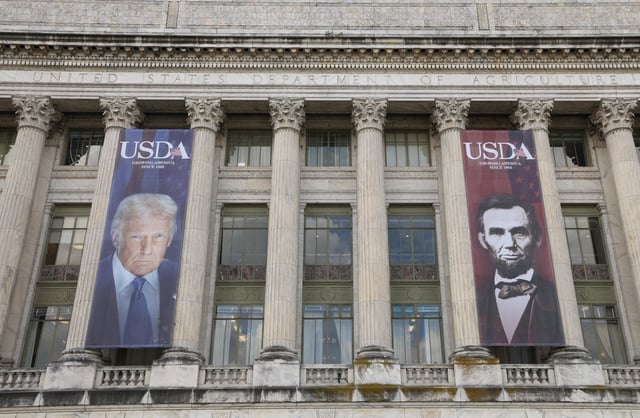Banners of U.S. President Donald Trump and President Abraham Lincoln reading "Growing America Since 1862" hang over the entrance to the United States Department of Agriculture in Washington, D.C., U.S., May 15, 2025. REUTERS/Kevin Lamarque/File Photo