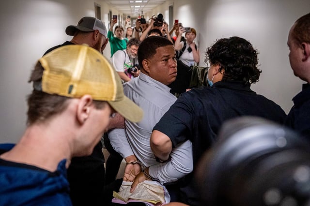 A man is detained by plainclothes officers with Immigration and Customs Enforcement on June 6, 2025 in New York City.