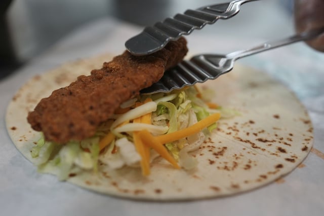 Charles L. Krumsiek, a McDonald's chef, puts a chicken on a tortilla to make a snack wrap at McDonald's Headquarter in Chicago, Thursday, May 29, 2025.