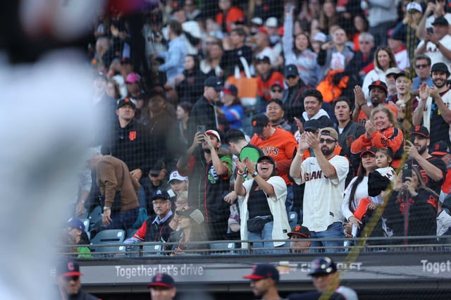 Fans at Oracle Park exult as designated hitter Rafael Devers walks to the plate to bat for his first plate appearances with the Giants in the first inning against the Cleveland Guardians on June 17.