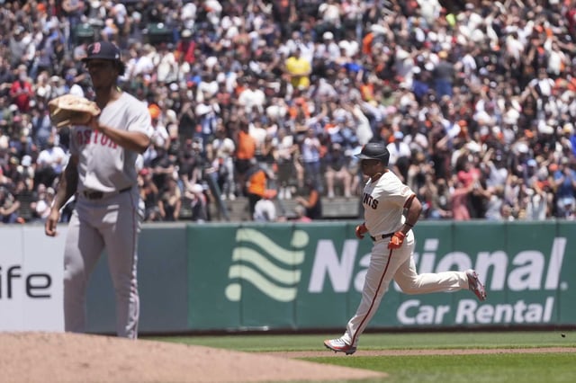 Giants designated hitter Rafael Devers circles the bases after hitting a two-run home run against the Boston Red Sox, his former team, and starting pitcher Brayan Bello, left, during the third inning on June 21 at Oracle Park.