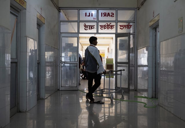 A relative of a patient stands next to a stretcher inside a hospital in Ballia District in the northern state of Uttar Pradesh, India, June 22, 2023. REUTERS/Adnan Abidi/File Photo