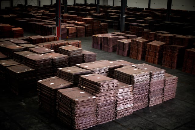 Copper cathodes are seen inside a warehouse near Yangshan Deep Water Port, south of Shanghai March 23, 2012. REUTERS/Carlos Barria/File Photo