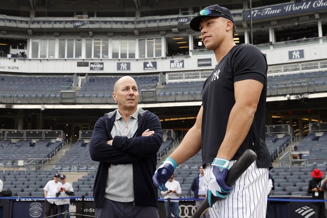 NEW YORK, NY - APRIL 4: General Manager, Brian Cashman talks to Aaron Judge #99 of the New York Yankees before the game against the Philadelphia Phillies at Yankee Stadium on April 4, 2023 in New York, New York.