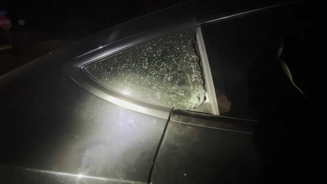 A window on a Tesla is shattered after a freeway shooting early Thursday. (July 10, 2025)