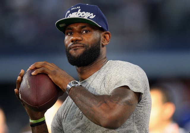 NBA player Lebron James of the Miami Heat throws a football at AT&amp;T Stadium before a Sunday night game between the New York Giants and the Dallas Cowboys on September 8, 2013 in Arlington, Texas.