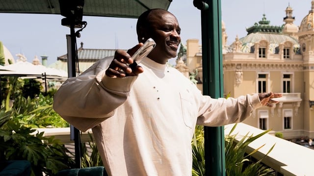 Akon looking off a balcony