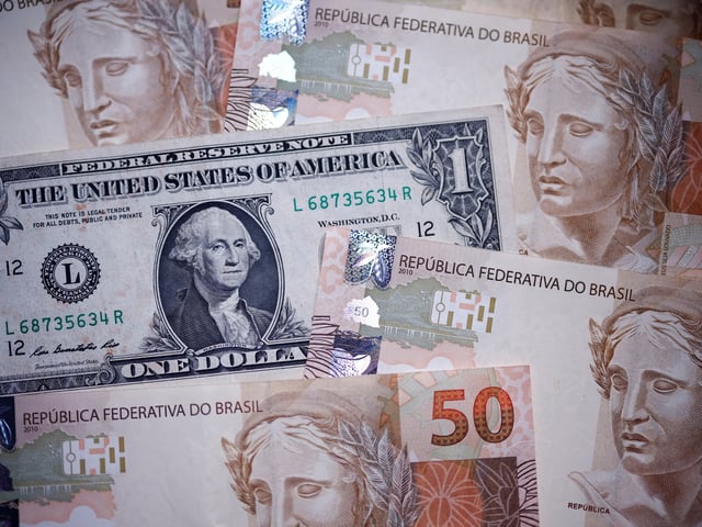Brazilian real and a U.S. dollar notes are seen in this illustration taken December 18, 2024. REUTERS/Amanda Perobelli/Illustration