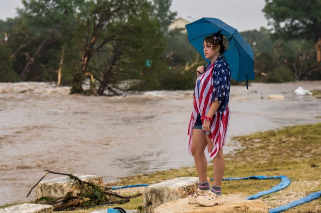 Kerrville resident Leighton Sterling watches flood waters along the Guadalupe River on July 4, 2025 in Kerrville, Texas.