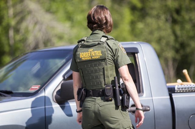A U.S. Border Patrol agent questions a driver at a highway checkpoint on August 1, 2018 in West Enfield, Maine. The checkpoint took place approximately 80 miles from the US/Canada border.