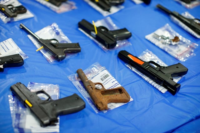 Pistols are displayed after a gun buyback event organized by the New York City Police Department (NYPD), in the Queens borough of New York City, U.S., June 12, 2021. REUTERS/Eduardo Munoz/File Photo