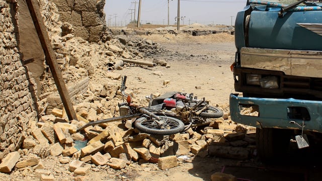A general view shows damaged vehicles at the site a day after a bomb blast in Qila Abdullah, in Balochistan province, on May 19, 2025. 