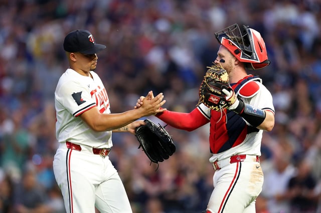 MINNEAPOLIS, MINNESOTA - JULY 09: Jhoan Duran #59 (L) and Ryan Jeffers #27 of the Minnesota Twins celebrate the win against the Chicago Cubs after the game at Target Field on July 09, 2025 in Minneapolis, Minnesota. The Twins defeated the Cubs 4-2.