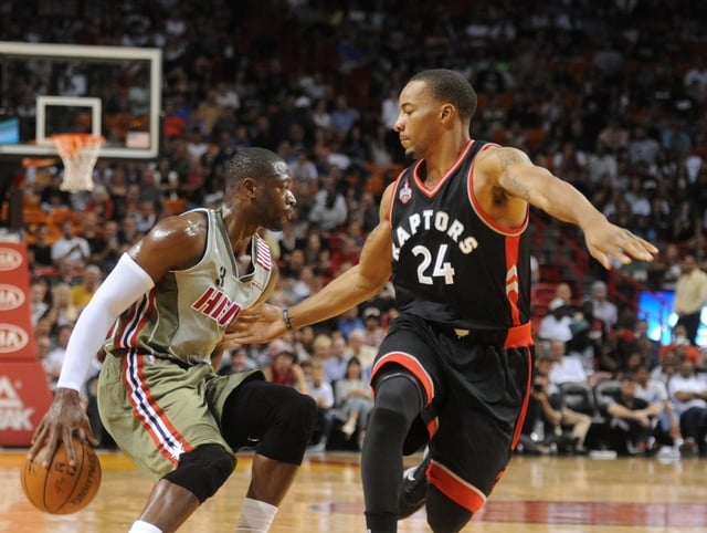 Miami Heats Dwyane Wade goes behind his back against the  Toronto Raptors Norman Powell, Sunday, Nov. 8, 2015, at the American Airlines in Miami.  (Joe Cavaretta, Sun Sentinel)