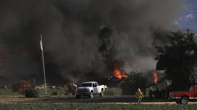 Smoke and flames rise after deadly explosions at a fireworks operation in Esparto (Yolo County) on July 1, 2025.