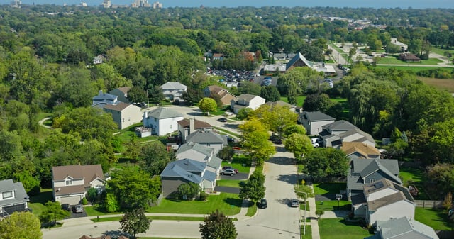 Aerial still image of houses in Waukegan, the most populous city in Lake County, Illinois on a clear day in Fall.
