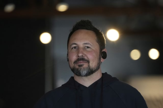 FILE - Jason Rugolo, founder and CEO of iyO, wears the iyO One audio computer in his ears while being interviewed at the company's office in Redwood City, Calif., Tuesday, June 24, 2025. (AP Photo/Jeff Chiu, File)
