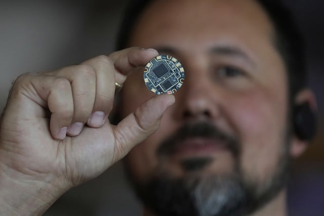 FILE - Jason Rugolo, founder and CEO of iyO, shows the motherboard of the iyO One audio computer while being interviewed at the company's office in Redwood City, Calif., Tuesday, June 24, 2025. (AP Photo/Jeff Chiu, File)