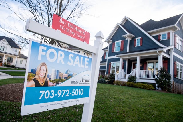 A house&#39;s real estate for sale sign is seen in front of a home in Arlington, Virginia, November 19, 2020.