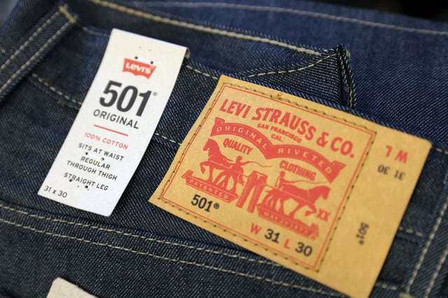 The Levi Strauss & Co. label is seen on jeans in a store at the Woodbury Common Premium Outlets in Central Valley, New York, U.S., February 15, 2022. REUTERS/Andrew Kelly/ File Photo