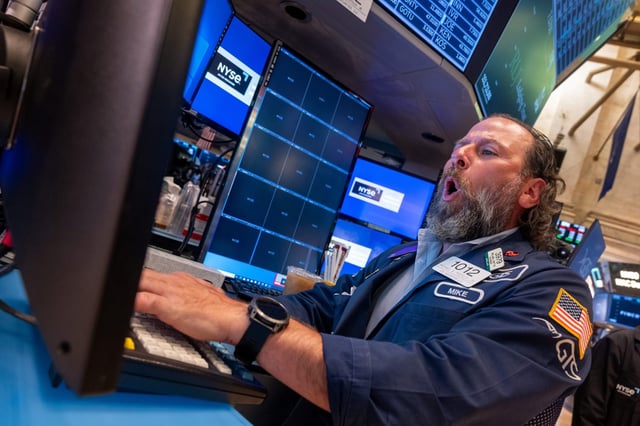 A trader works on the New York Stock Exchange, where stock continue to march higher.