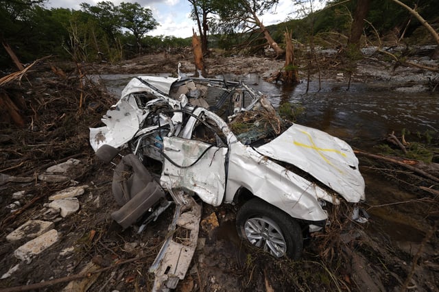 A destroyed vehicle sits next to the Guadalupe River on Wednesday, July 9, 2025, in Hunt, Texas, after a flash flood swept through the area. (AP Photo/Gerald Herbert)
