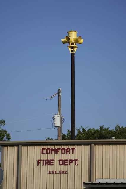 An emergency siren is visible on top of the Comfort Volunteer Fire Department in Comfort, Texas on Thursday, July 10, 2025. (AP Photo/Ashley Landis)