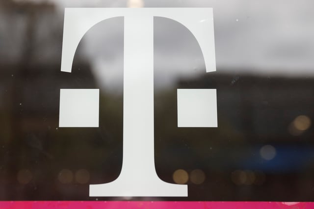 A T-Mobile logo is seen on the storefront door of a store in Manhattan, New York, U.S., April 30, 2018. REUTERS/Shannon Stapleton