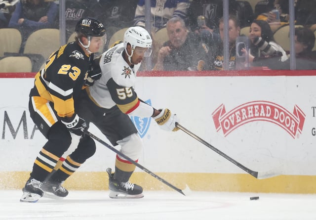 Mar 11, 2025; Pittsburgh, Pennsylvania, USA;  Pittsburgh Penguins defenseman Vladislav Kolyachonok (23) pressures Vegas Golden Knights right wing Keegan Kolesar (55) during the first period at PPG Paints Arena. Mandatory Credit: Charles LeClaire-Imagn Images/File Photo