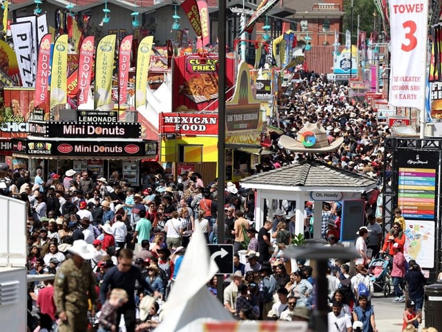 People fill the midway during Family Day at the Calgary Stampede on July 6, 2025. 