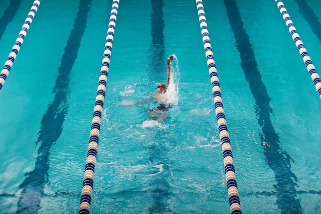 Adding more resistance — such as swimming against the water — can ramp up a workout.