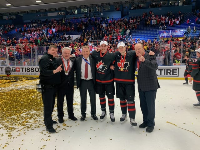 Ostrava, Czechia - Gold medal celebration at the world junior hockey championship. (Left to right: Chris Maton, Dale Hunter, Bob Martin, Liam Foudy, Connor McMichael, Mark Hunter)