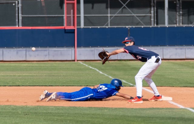 Sunnyside Blue Devils Emrick Thompson (11) slides back to first base against Pinnacle Pioneers Chase Gonzalez (12) during a game at Pinnacle High School in Phoenix, on April 30, 2025.