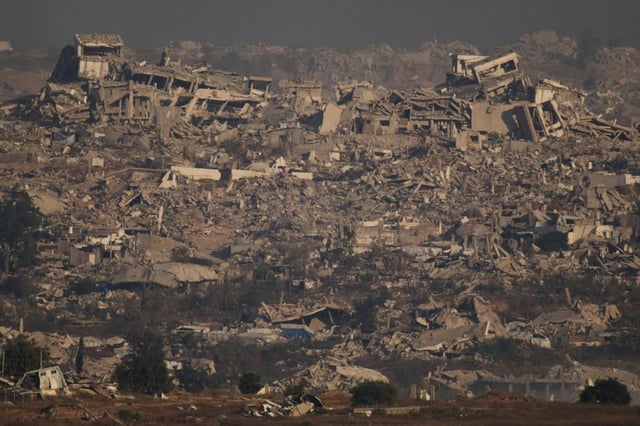 Buildings that were destroyed during the Israeli ground and air operations stand in northern of Gaza Strip as seen from southern Israel, Thursday, July 10, 2025. (AP Photo/Leo Correa)