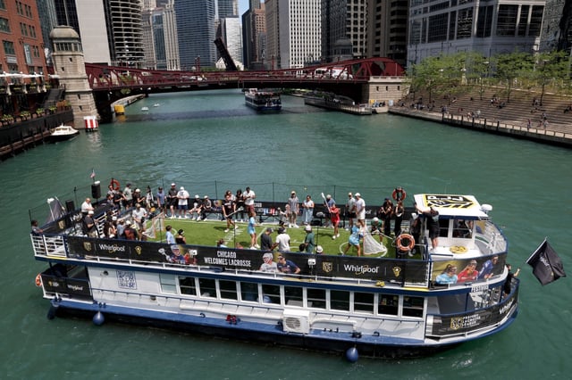 New York Charging (in blue) plays against the Maryland Charm (in red) in a first-ever-lacrosse game on a boat on the Chicago River on July 10, 2025. (Antonio Perez/Chicago Tribune)