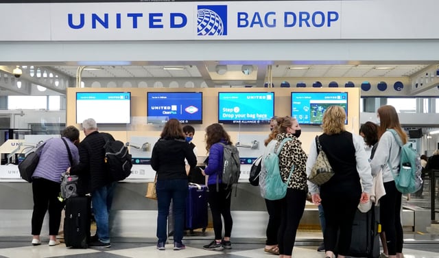 Travelers arrive for flights at O’Hare International Airport in Chicago on March 16, 2021.
