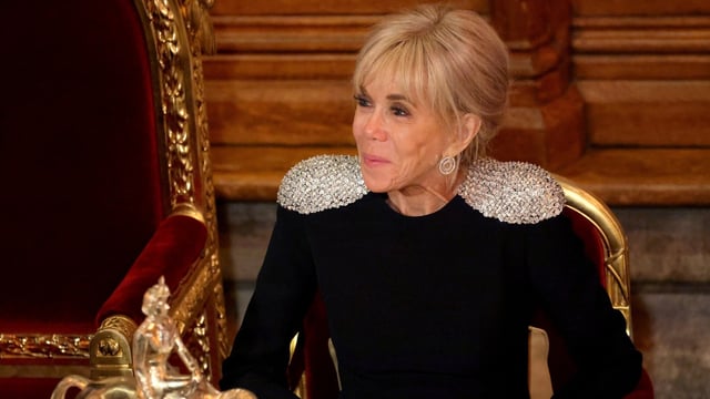 French President's wife Brigitte Macron looks on during a State Banquet
