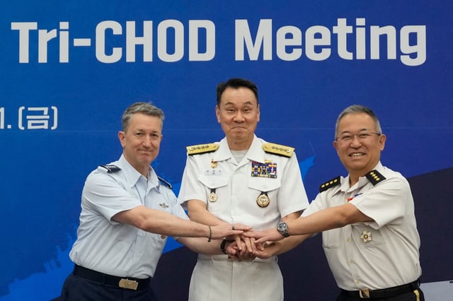 General Yoshihide Yoshida, Chief of Staff, Joint Staff of Japan, Admiral Kim Myung-soo, chairman of the South Korean Joint Chiefs of Staff, and John Daniel Caine, chairman of the U.S. Joint Chiefs of Staff, pose during a Trilateral Chiefs of Defense meeting at the Defense Ministry in Seoul, South Korea, Friday, July 11, 2025.     Ahn Young-joon/Pool via REUTERS