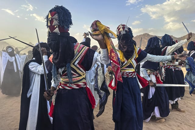 Zelouaz, Algeria dancers perform on the last day of the Sebeiba festival in Djanet, a southeastern Algerian oasis town in the Sahara desert, on July 6, 2025. (AP Photo/Audrey Thibert)