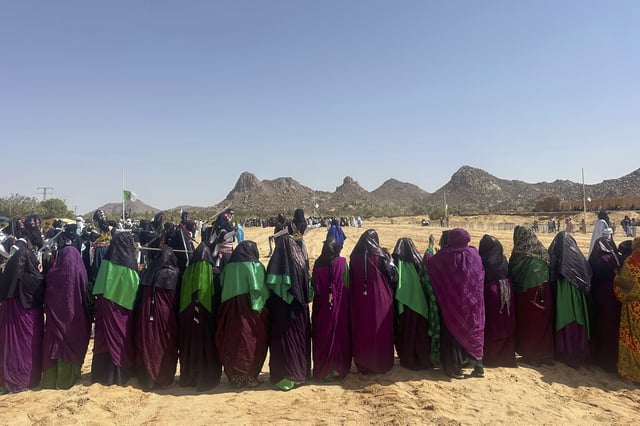 Female performers from El Mihan, Algeria stand together during the Sebeiba festival dance competition in Djanet, a southeastern Algerian oasis town in the Sahara desert, on July 6, 2025. (AP Photo/Audrey Thibert)