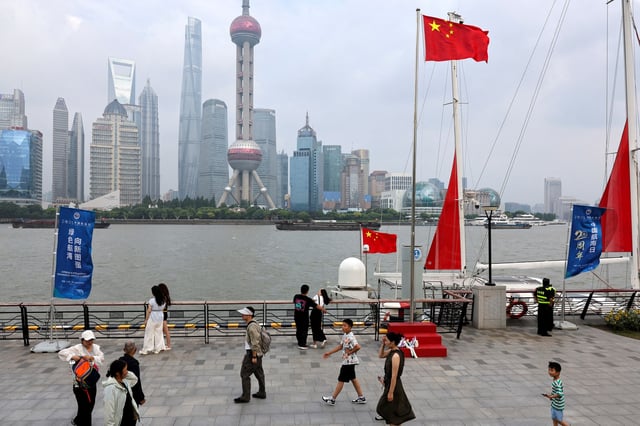 People walk on a promenade in Shanghai, China, July 10, 2025.  REUTERS/Go Nakamura/File Photo