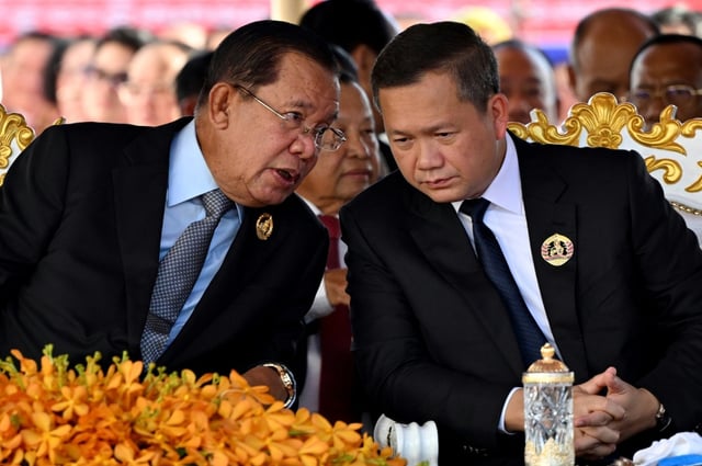 Hun Sen (left) speaks to his son Hun Manet during a ceremony marking the 74th founding anniversary of the Cambodian People’s Party in Phnom Penh in June