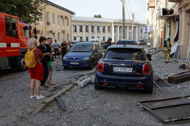 Residents gather at the site of a Russian drone strike, amid Russia's attack on Ukraine, in the downtown of Kharkiv, Ukraine July 11, 2025. REUTERS/Sofiia Gatilova