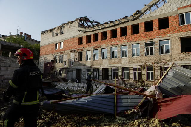 Firefighters work at the site of a building hit by a Russian drone strike, amid Russia's attack on Ukraine, in the downtown of Kharkiv, Ukraine July 11, 2025. REUTERS/Sofiia Gatilova