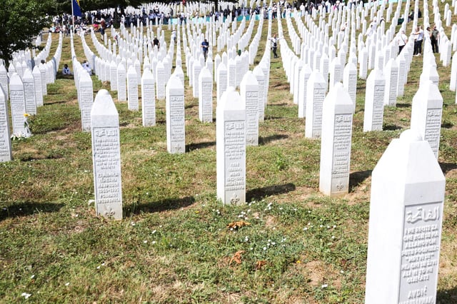 Bosnian Muslims gather amid grave stones of victims killed during the Srebrenica genocide, at the Srebrenica Genocide Memorial in Potocari, Bosnia and Herzegovina, July 11, 2025. REUTERS/Amel Emric     TPX IMAGES OF THE DAY