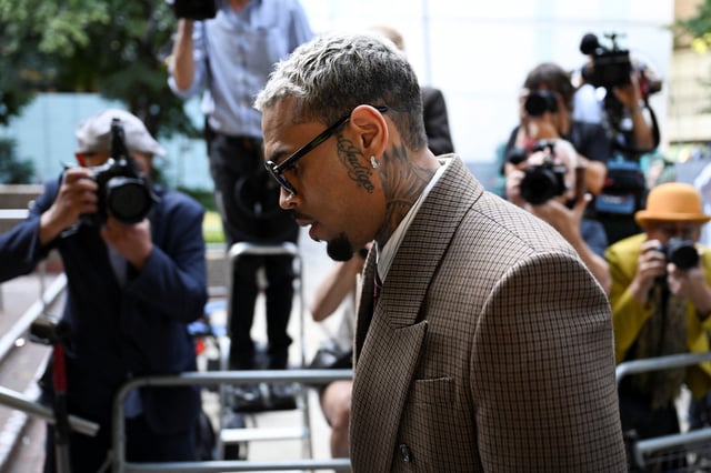 U.S. singer Chris Brown, who has been charged with inflicting grievous bodily harm in what prosecutors said was an "unprovoked attack" on a music producer at the Tape nightclub in central London in 2023, walks outside the Southwark Crown Court in London, Britain, July 11, 2025. REUTERS/Chris J. Ratcliffe