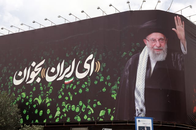This picture shows a billboard bearing the portrait of Iranian supreme leader Ayatollah Ali Khamenei and a quote reads in Persian &#39;Sing Oh Iran&#39; at the Enqelab Square in Tehran on July, 9, 2025.