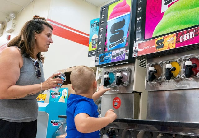 Michele, left, and Jordan Trobman, 6, from Bensalem, Pennsylvania get Slurpees on Free Slurpee Day at the 7-Eleven in Langhorne, Penn., on July 11, 2024.