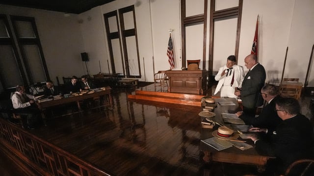Larry Jones, who portrays William Jennings Bryan, in white suit, rehearses with other actors in the play "Destiny in Dayton", July 8, 2025, in Dayton, Tenn. (AP Photo/Mike Stewart)